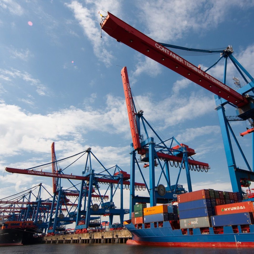 red and blue crane under blue sky during daytime